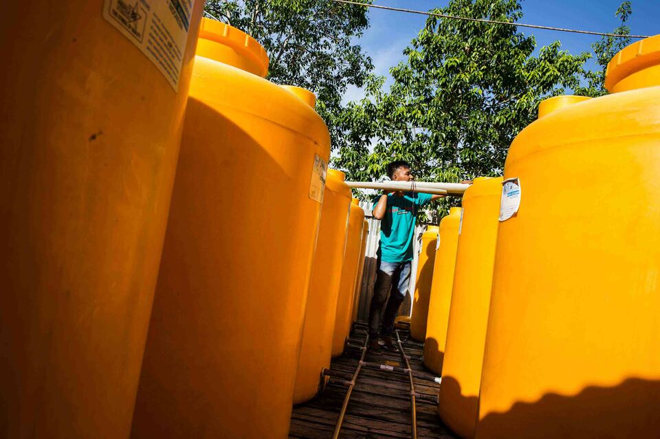 A resident inspects rainwater distribution pipes in Agats, Papua, on Thursday (25/01). Local residents use rain water to bathe and drink. (Antara Photo/M Agung Rajasa)