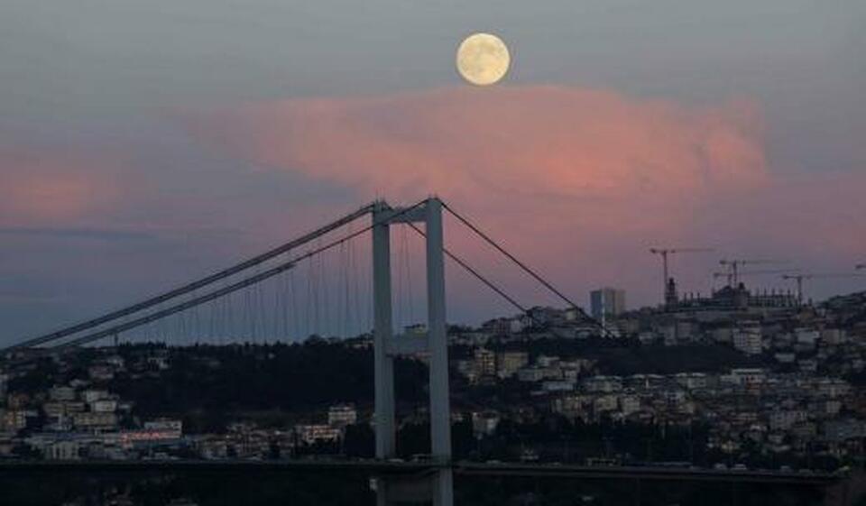 A full moon rises over the Bosphorus bridge in Istanbul. (Reuters Photo/Murad Sezer)