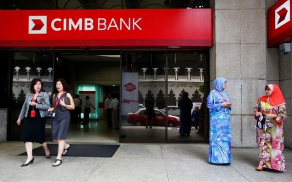 People are seen in front of a CIMB bank office in Kuala Lumpur February 25, 2014.   (Reuters Photo/Samsul Said)