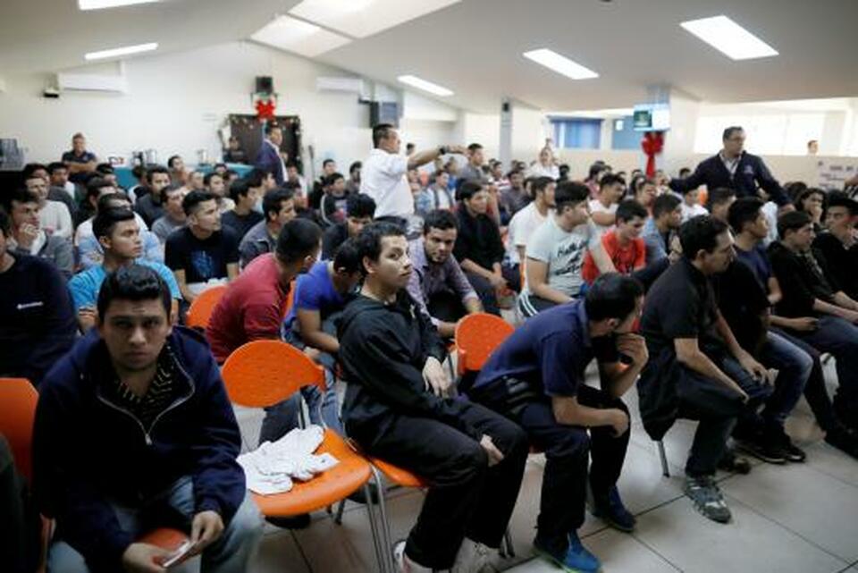 Deportees wait to be processed at an immigration facility after a flight carrying illegal immigrants from the United States arrived in San Salvador on Jan. 11. (Reuters Photo/Jose Cabezas)