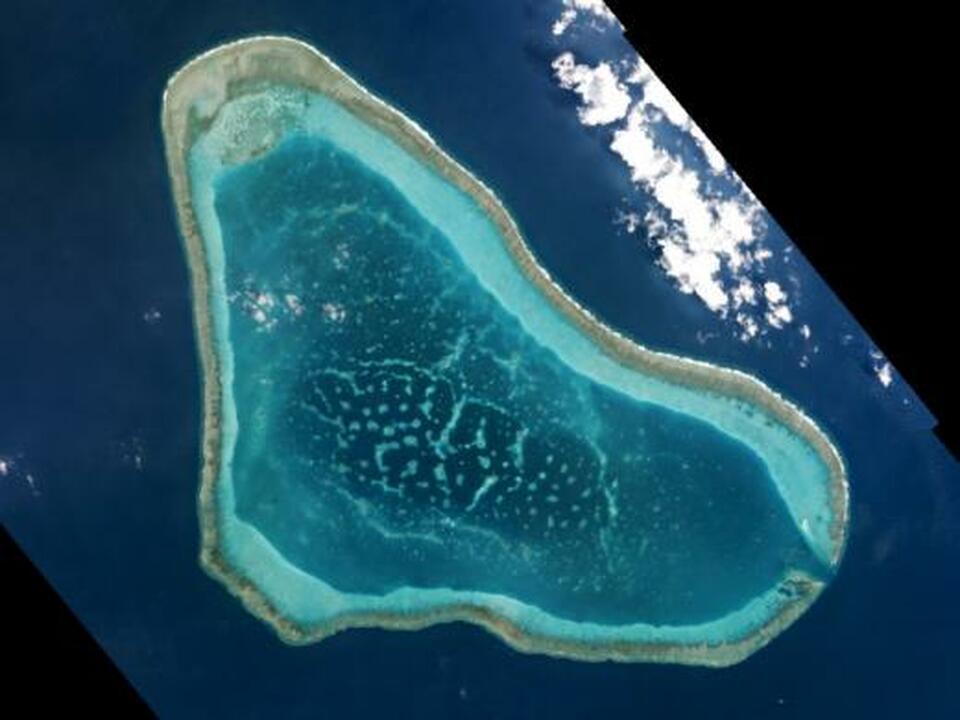 Boats at Scarborough Shoal in the South China Sea are shown in this handout photo provided by Planet Labs, and captured on March 12, 2016. (Reuters Photo/Planet Labs)
