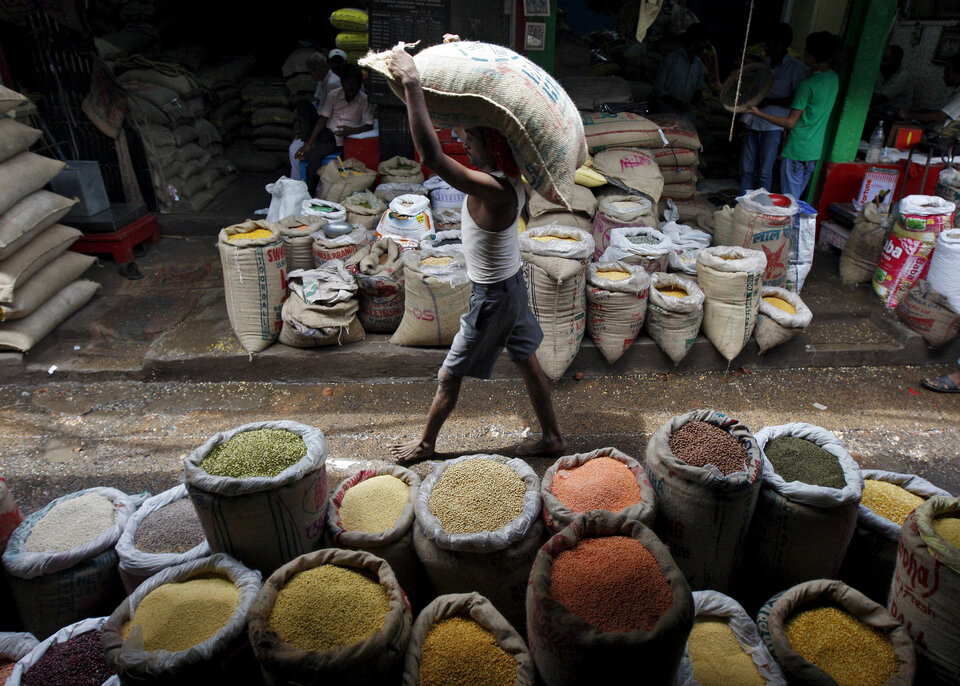 A man carries a sack filled with pulses at a wholesale pulses market in Kolkata. (Reuters Photo/Rupak De Chowdhuri)