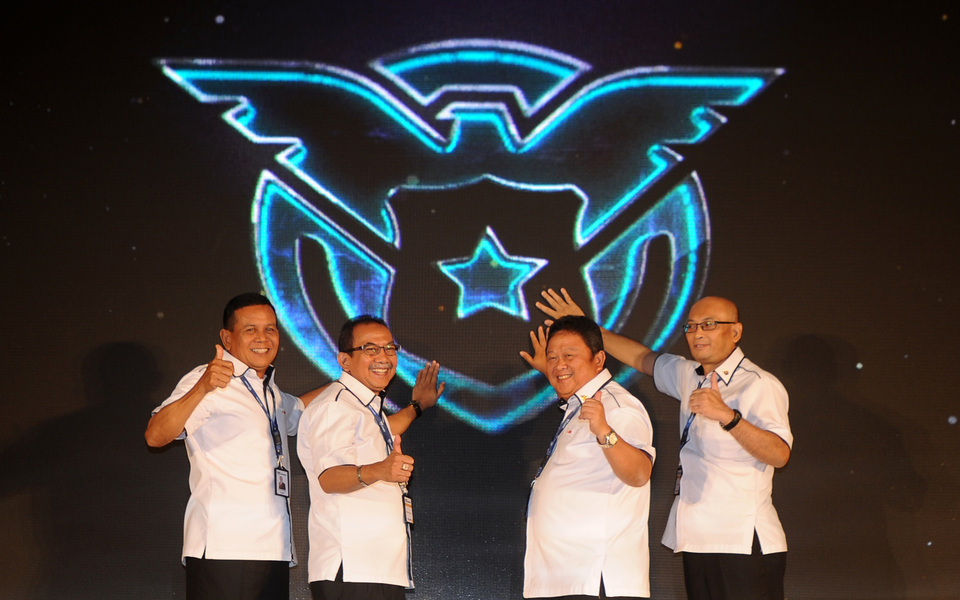 In this Feb. 27, 2018 photo, top executives of state insurer Asabri pose for a photo in front of the company's new logo. Among them is president director Sonny Widjaja, left, who is currently implicated for alleged massive fraud in the company. (Antara Photo)