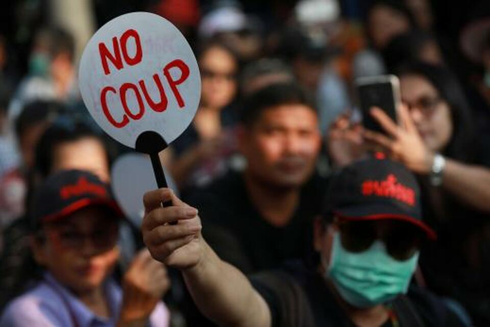 A Pro-democracy activist holds a fan during protest against junta near Democracy Monument in Bangkok, Thailand Feb. 10.  (Reuters Photo/Soe Zeya Tun)