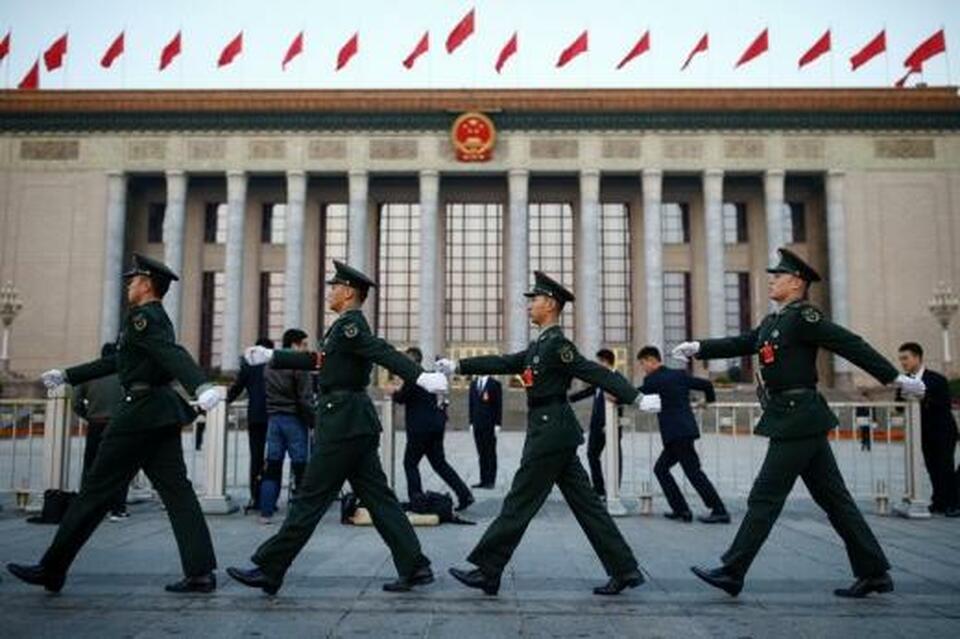 Paramilitary police march past the Great Hall of the People in Beijing. (Reuters Photo/Thomas Peter)