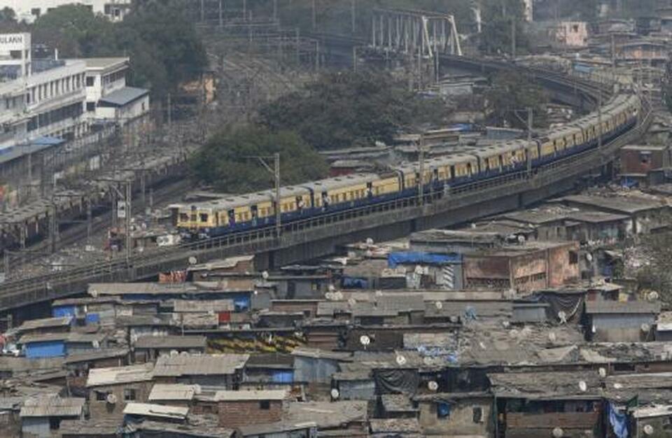 A suburban train passes through a slum area in Mumbai, India, in February 2016. (Reuters Photo/Shailesh Andrade)