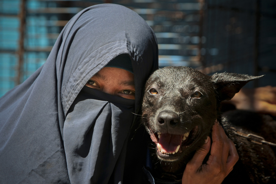 Hesti Sutrisno, 38, with John, a stray dog she rescued from the streets, at her house in Pamulang near Jakarta on Thursday (15/03). (JG Photo/Yudha Baskoro)