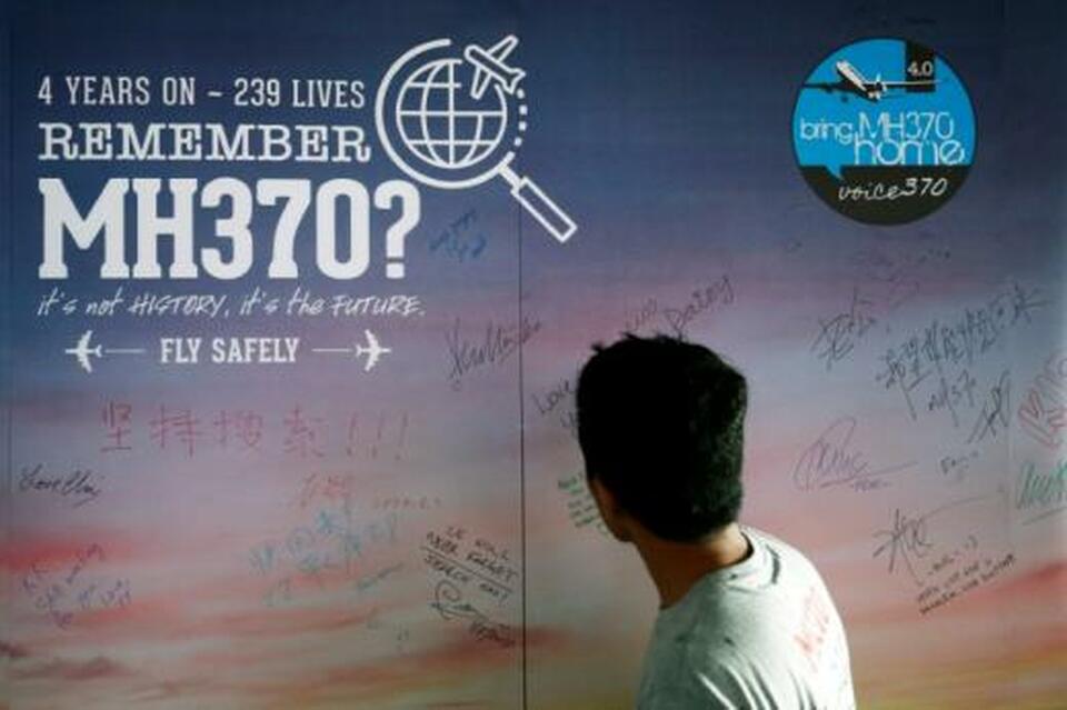 A man looks at a message board for passengers, onboard the missing Malaysia Airlines Flight MH370, during its fourth annual remembrance event in Kuala Lumpur, Malaysia March 3. (Reuters Photo/Lai Seng Sin)