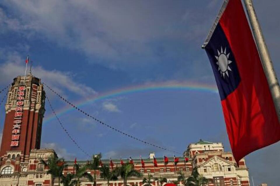 A rainbow is seen behind Taiwanese flag during the National Day celebrations in Taipei, Taiwan, October 10, 2017. (Reuters/Tyrone Siu)