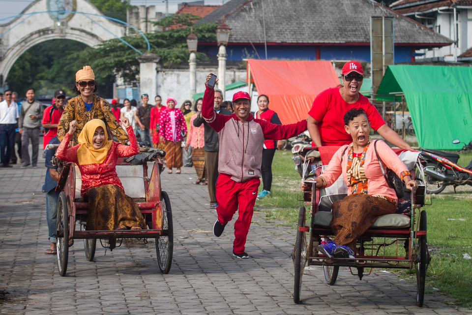 Female members of the Solo Pedestrian Community compete in a pedicab race at South Square in Solo, Central Java, on Saturday (21/04) as part of Kartini Day celebrations. (Antara Photo/Mohammad Ayudha)