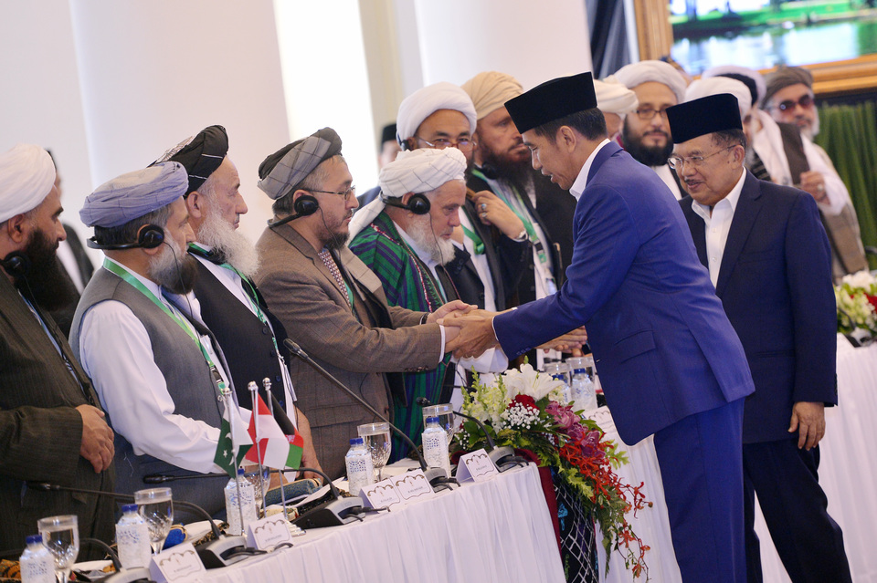 President Joko Widodo and Vice President Jusuf Kalla greet the ulema attending a trilateral conference of Muslim scholars in Bogor, West Java, on Friday (11/05). (Antara Photo/Wahyu Putro A)