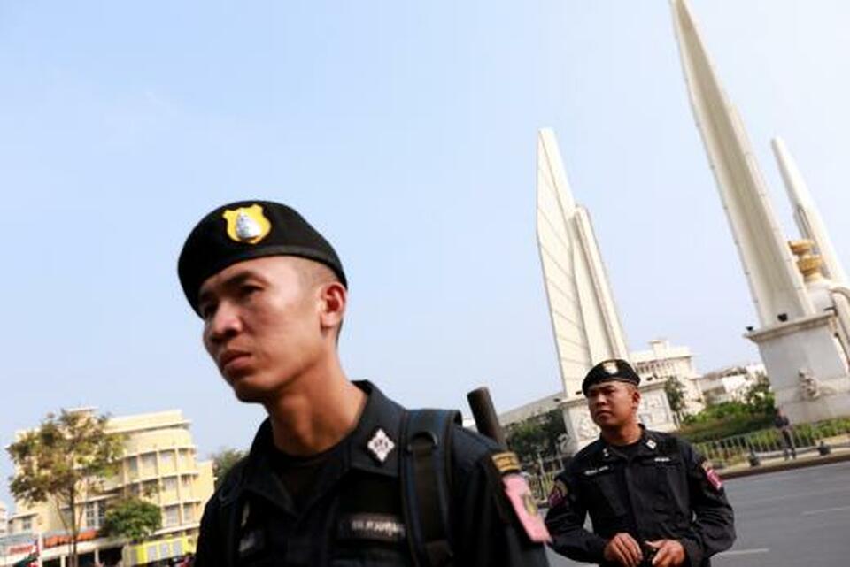 Police officers stand guard during a pro-democracy protest against the governing junta near Democracy Monument in Bangkok in this Feb. 10, 2018 file photo. (Reuters Photo/Soe Zeya Tun)
