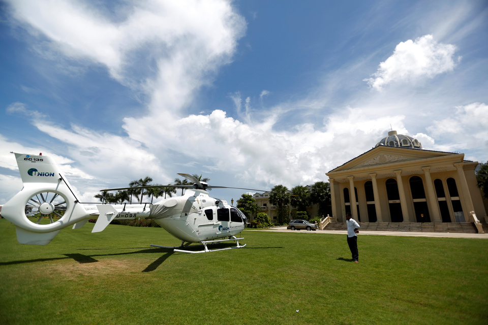 A man stands near a Union Development Group helicopter in front of an old casino at Dara Sakor hotel   at Botum Sakor in Koh Kong province, Cambodia. (Reuters Photo/Samrang Pring)