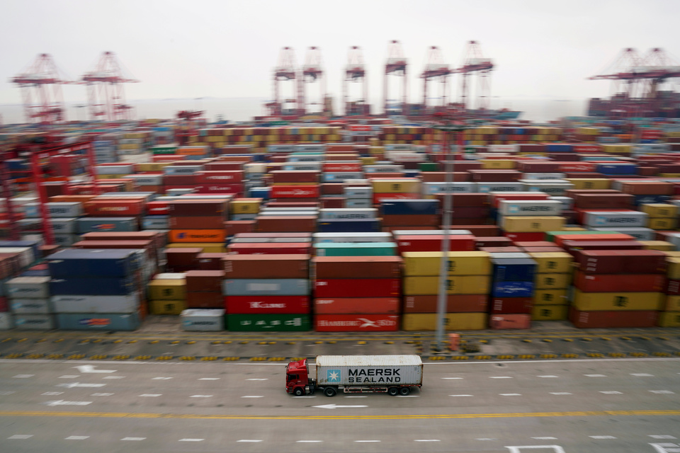 A container truck moves past containers at the Yangshan Deep Water Port in Shanghai, China. (Reuters Photo/Aly Song)