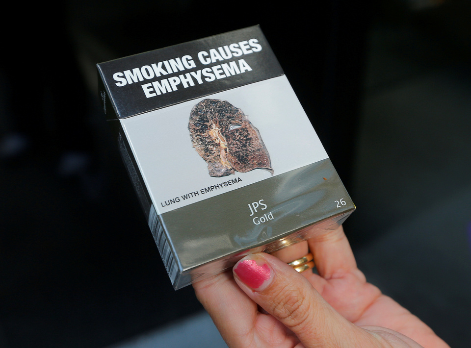 A photo illustration shows restrictive tobacco packaging on cigarettes outside a Sydney office building in Australia. (Reuters Photo/Jason Reed)