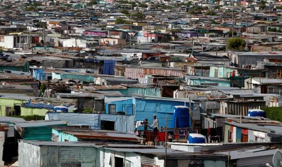 Residents walk through crowded shacks in Khayelitsha township, near Cape Town, South Africa. (Reuters Photo/Mike Hutchings)