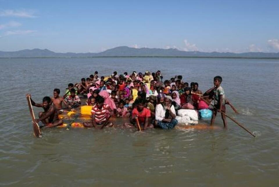 Rohingya refugees cross the Naf River with an improvised raft to reach to Bangladesh at Sabrang near Teknaf, Bangladesh. (Reuters Photo/Mohammad Ponir Hossain)