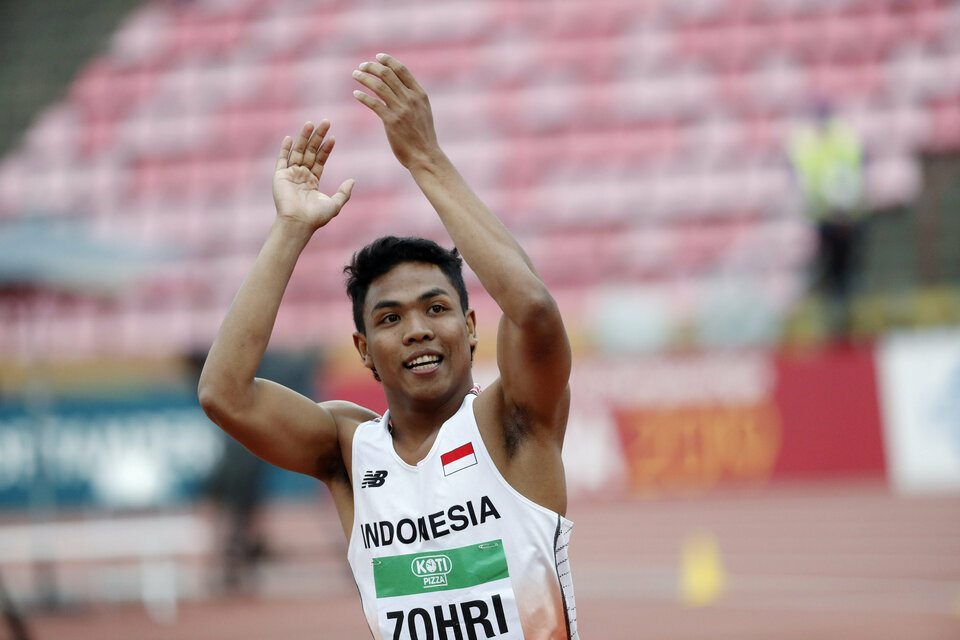 Lalu Muhammad Zohri of Indonesia celebrates his victory at the 2018 IAAF World U20 Championships in Tampere, Finland on Wednesday (11/07). (Reuters Photo/Lehtikuva/Kalle Parkkinen)