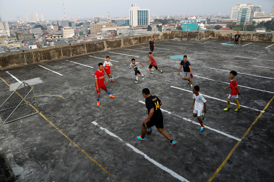 Residents play football on the top floor of a parking garage in Jakarta in this May 4, 2018 file photo. (Reuters Photo/Darren Whiteside)