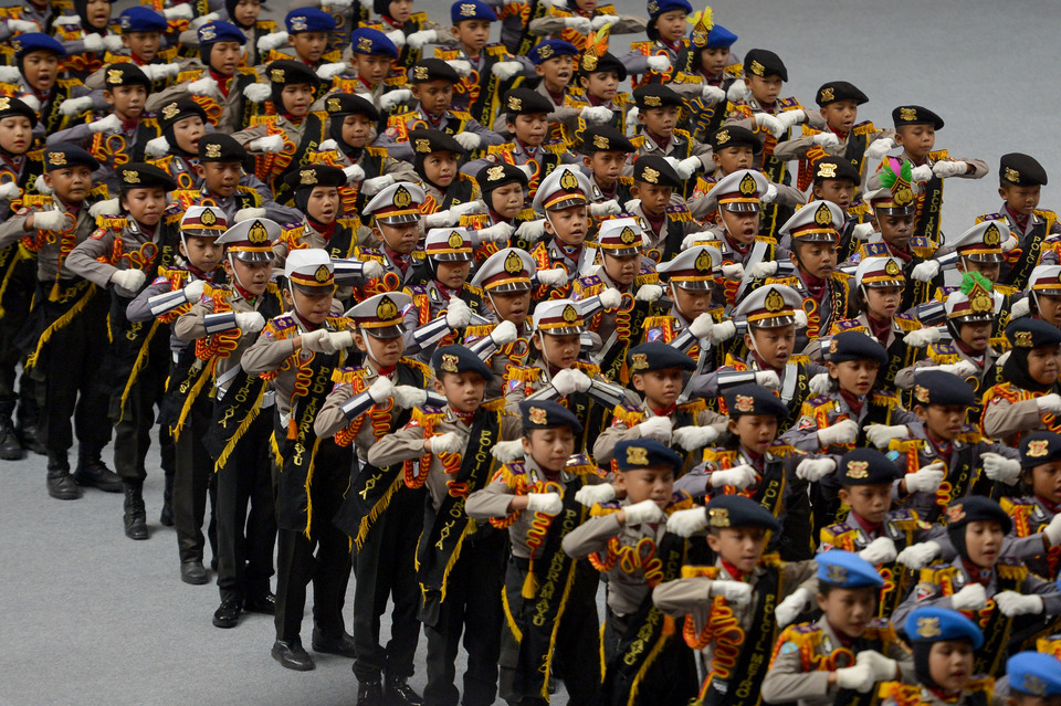 Children dressed as police march for President Joko "Jokowi" Widodo during a celebration to observe the 72nd anniversary of the National Police at Istora Senayan, Jakarta, Wednesday (11/07). (Antara Photo/Wahyu Putro A)