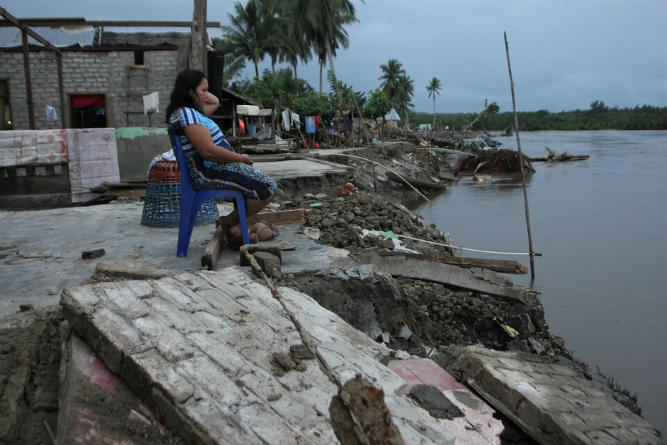 A woman stands in debris of her house destroyed by the Konaweha River in Muara Sampara village, Kapoiala, Konawe, Southeast Sulawesi, on Thursday (12/07). Thirty households in Lalibue Village and Muara Sampara were washed away by the river. (Antara Photo/Jojon)