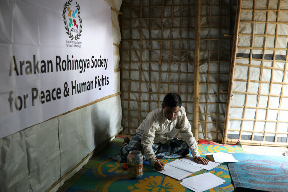 Mohib Bullah, a member of Arakan Rohingya Society for Peace and Human Rights, writes after collecting data about victims of a military crackdown in Myanmar, at Kutupalong camp in Cox's Bazar, Bangladesh, on April 21, 2018. (Reuters Photo/Mohammad Ponir Hossain)