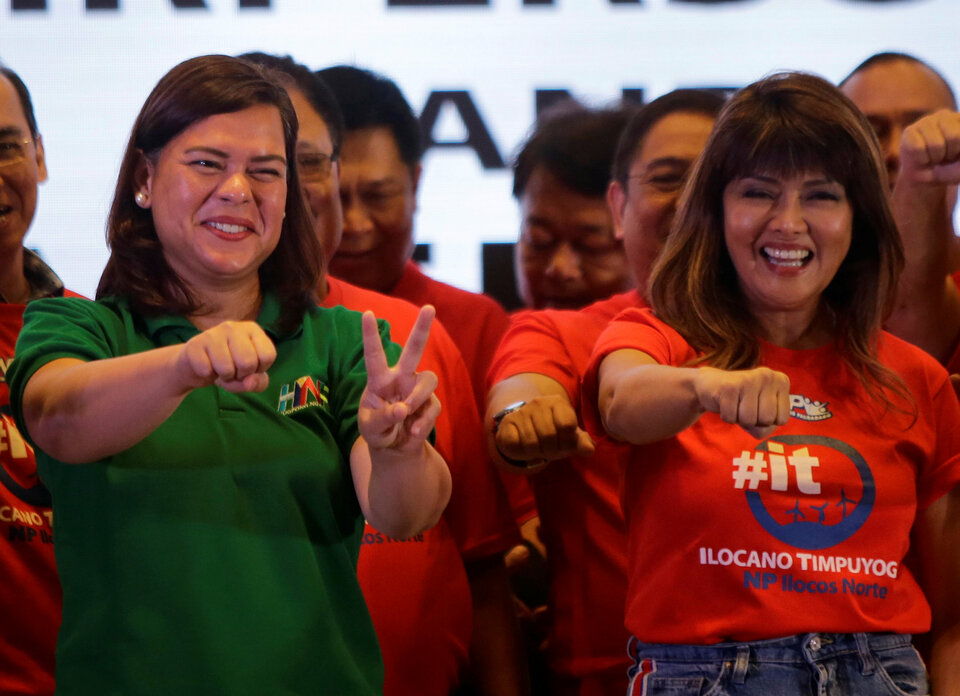 Davao City Mayor Sara Duterte-Carpio, left,  and Ilocos Norte Governor Imee Marcos gesture during an alliance meeting with local political parties in Paranaque, Metro Manila in Philippines, Aug. 13. (Reuters Photo/Czeasar Dancel)