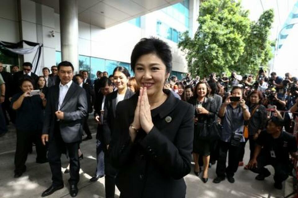 Ousted former Thai Prime Minister Yingluck Shinawatra gestures in a traditional greeting as she leaves the Supreme Court in Bangkok, Thailand. (Reuters Photo/Athit Perawongmetha)