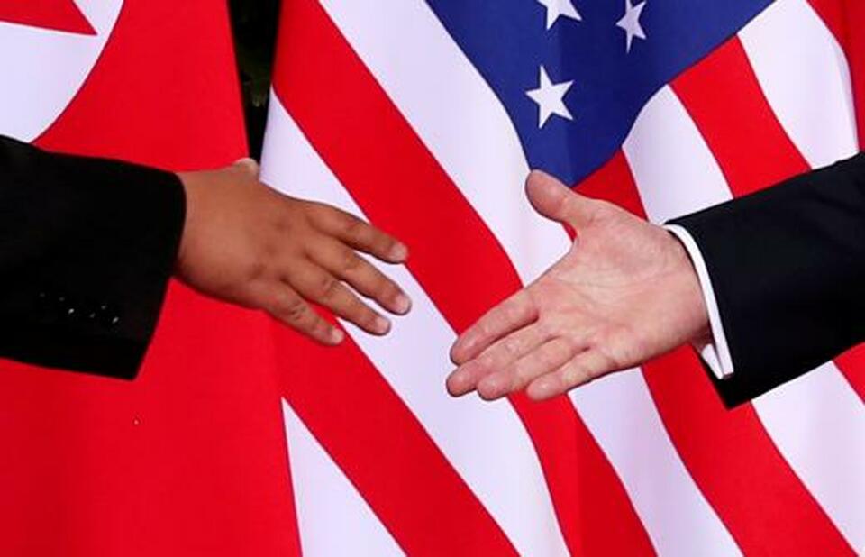 US President Donald Trump shakes hands with North Korean leader Kim Jong-un at the Capella Hotel on Sentosa Island in Singapore at the start of their June 12 meeting. (Reuters Photo/Jonathan Ernst)