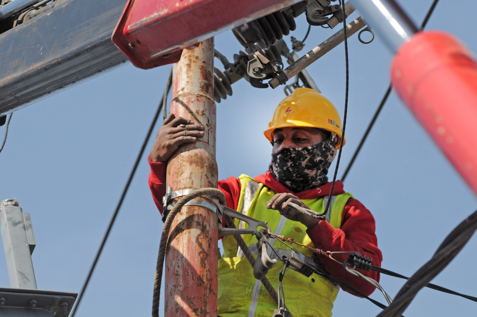 A PLN technician from Gorontalo repairs a damaged power line on a street in Palu, Central Sulawesi. (Antara Photo/Basri Marzuki)