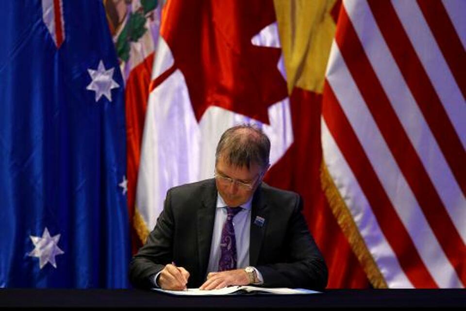 New Zealand's Minister for Trade and Export Growth David Parker signs the Trans-Pacific Partnership (TPP) trade deal, in Santiago, Chile on March 8, 2018. (Reuters Photo/Ivan Alvarado)