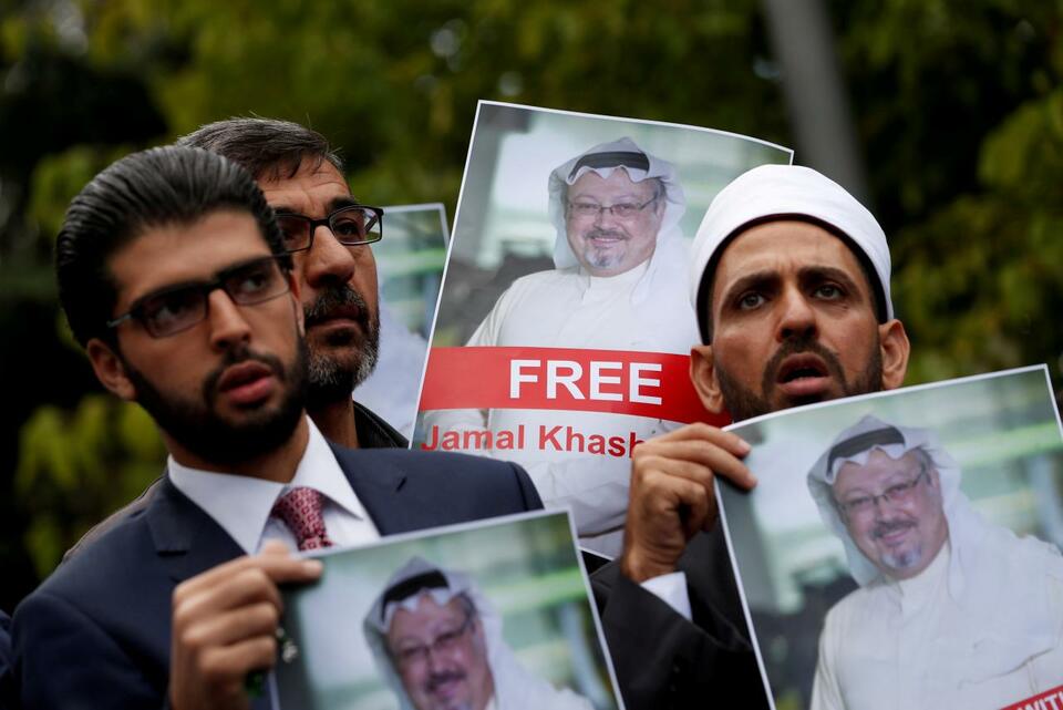 Human rights activists and friends of exiled Saudi journalist Jamal Khashoggi hold pictures of him during a protest outside the Saudi Consulate in Istanbul on Oct. 8. (Reuters Photo/Murad Sezer)