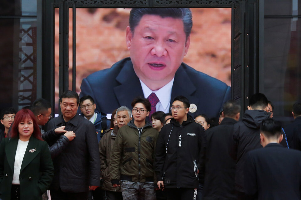 Visitors stand in front of a screen showing President Xi Jinping at an exhibition marking the 40th anniversary of China's reform and opening up at the National Museum of China in Beijing, Chinaon Wednesday. (Reuters Photo/Thomas Peter)