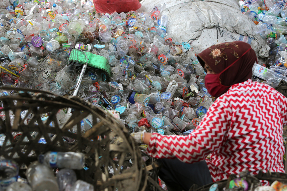 A woman sorting plastic waste for recycling in Gampong Jawa village in Banda Aceh on Nov. 6. The country produces 64 million tons of plastic waste per year, according to the Indonesian Plastic Industry Association (Inaplas) and the Central Statistics Agency (BPS). The government targets a 30 percent reduction in plastic waste by 2025. (Antara Photo/Irwansyah Putra)