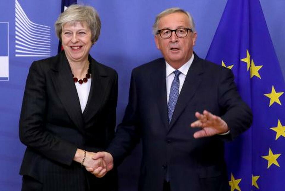 British Prime Minister Theresa May shakes hands with European Commission President Jean-Claude Juncker before a meeting to discuss draft agreements on Brexit, at the EC headquarters in Brussels, Belgium on Wednesday. (Reuters Photo/Yves Herman)