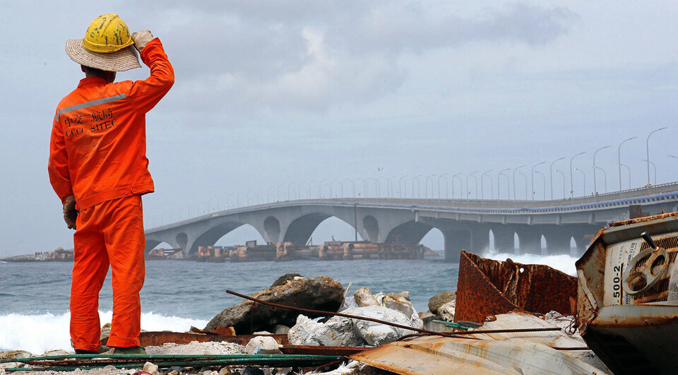 FILE PHOTO: A construction worker looks on as the China-funded Sinamale bridge is seen in Male, Maldives September 18, 2018. REUTERS/Ashwa Faheem/File Photo