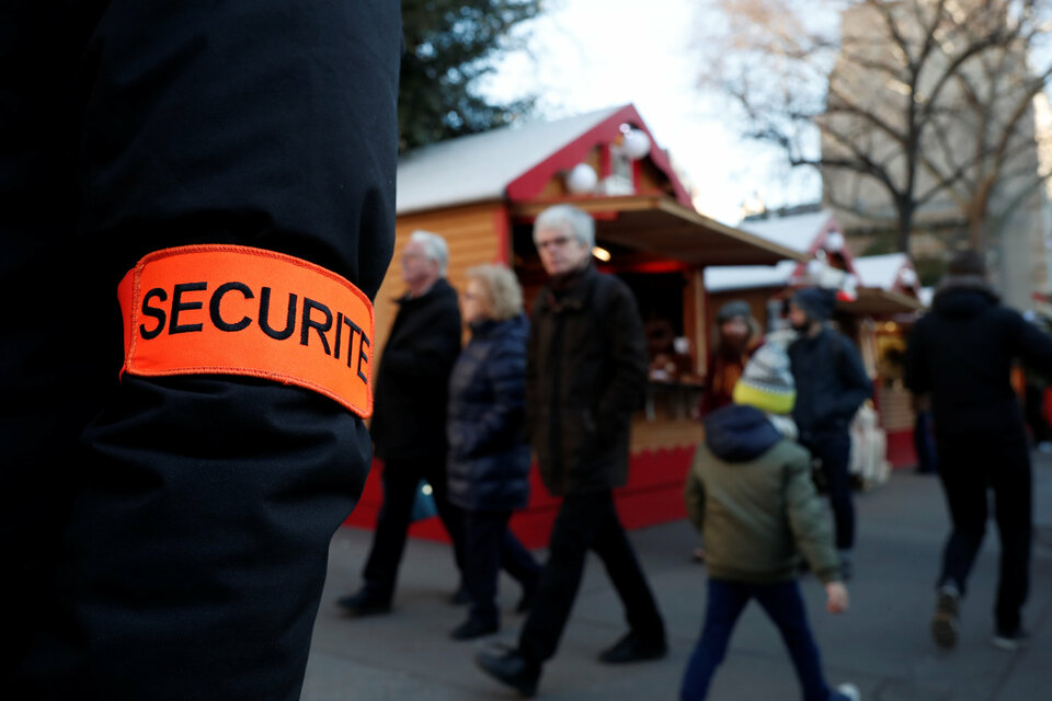 A security officer directs shoppers at the traditional Christmas market on the boulevard Saint-Germain in Paris on Wednesday. (Reuters Photo/Benoit Tessier)