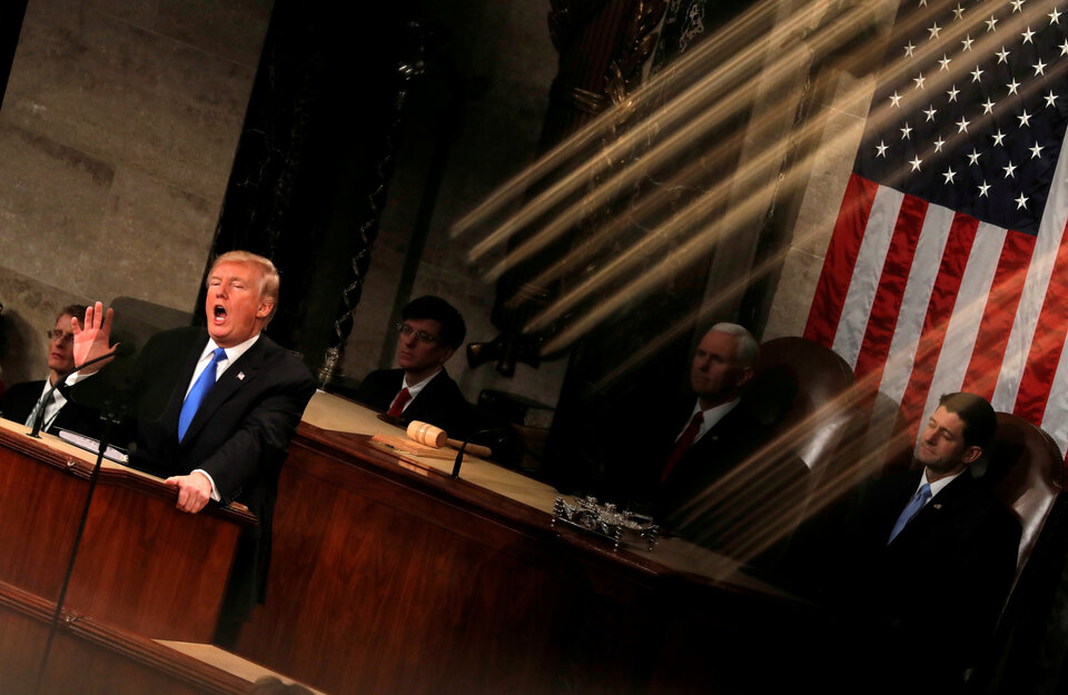 US President Donald Trump and Vice President Mike Pence are seen behind the reflection of a House chamber railing as Trump delivers his State of the Union address to a joint session of the US Congress on Capitol Hill in Washington, US, January 30, 2018.  (Reuters Photo/Carlos Barria)