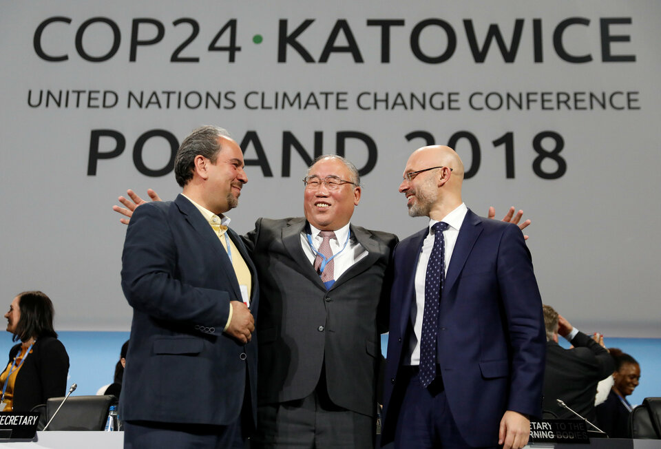 Iran's head of delegation Majid Shafiepour Motlagh, China's head of delegation Xie Zhenhua and COP24 President Michal Kurtyka smile after adopting the final agreement during a closing session of the COP24 UN Climate Change Conference 2018 in Katowice, Poland, on Saturday. (Reuters Photo/Kacper Pempel)