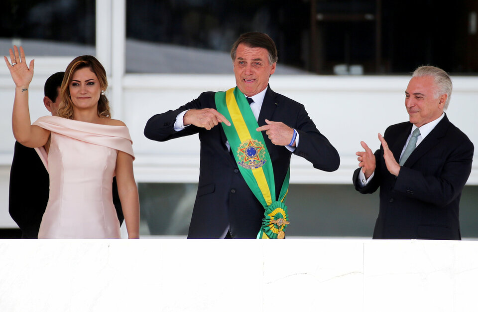 Brazil's new President Jair Bolsonaro gestures after receiving the presidential sash from outgoing President Michel Temer at the Planalto Palace, in Brasilia, Brazil January 1, 2019.  (Reuters Photo/Sergio Moraes)