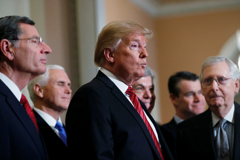 US President Donald Trump speaks to reporters between US Senate Majority Leader Mitch McConnell (R-KY) (R) and Sen. John Barrasso (R-WY) (L) after Trump addressed a closed Senate Republican policy lunch while a partial government shutdown enters its 19th day on Capitol Hill in Washington, US, January 9, 2019.  (Reuters Photo/Leah Millis)