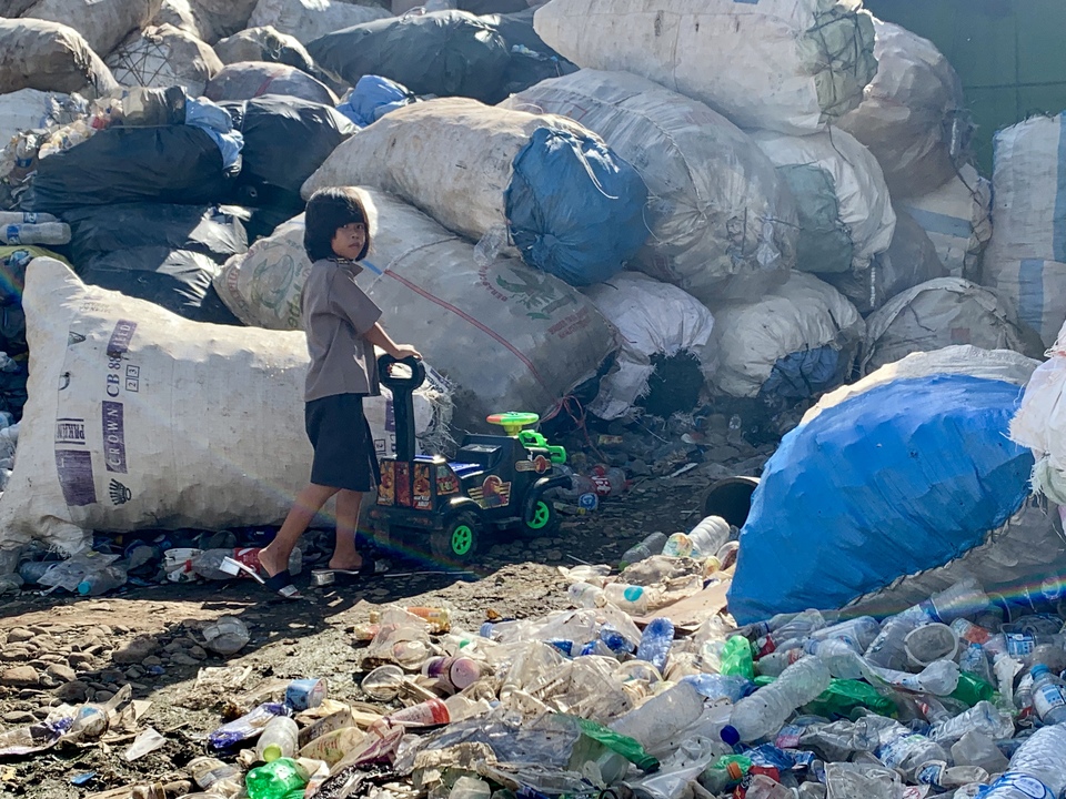 A young girl plays in her backyard at the Bantar Gebang landfill area in Bekasi, West Java. (JG Photo/Aleasha Bliss)
