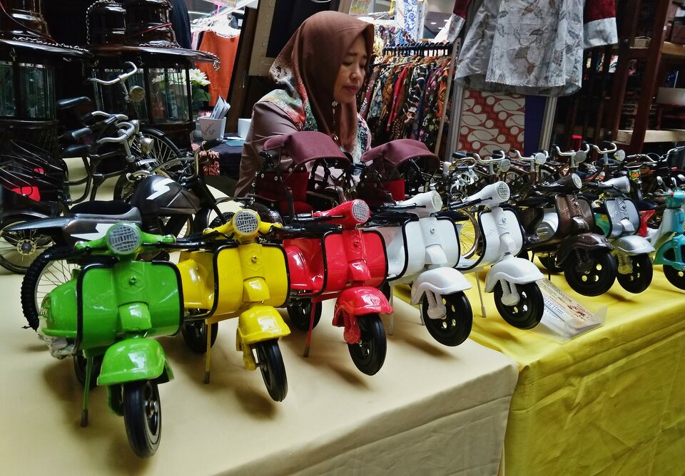 A woman stands in front of her miniature motorcycles at the MSME exhibition held by the Indonesian Businesswomen's Association (Iwapi) in Semarang on Feb 27, 2019. (Antara Photo/R. Rekotomo)