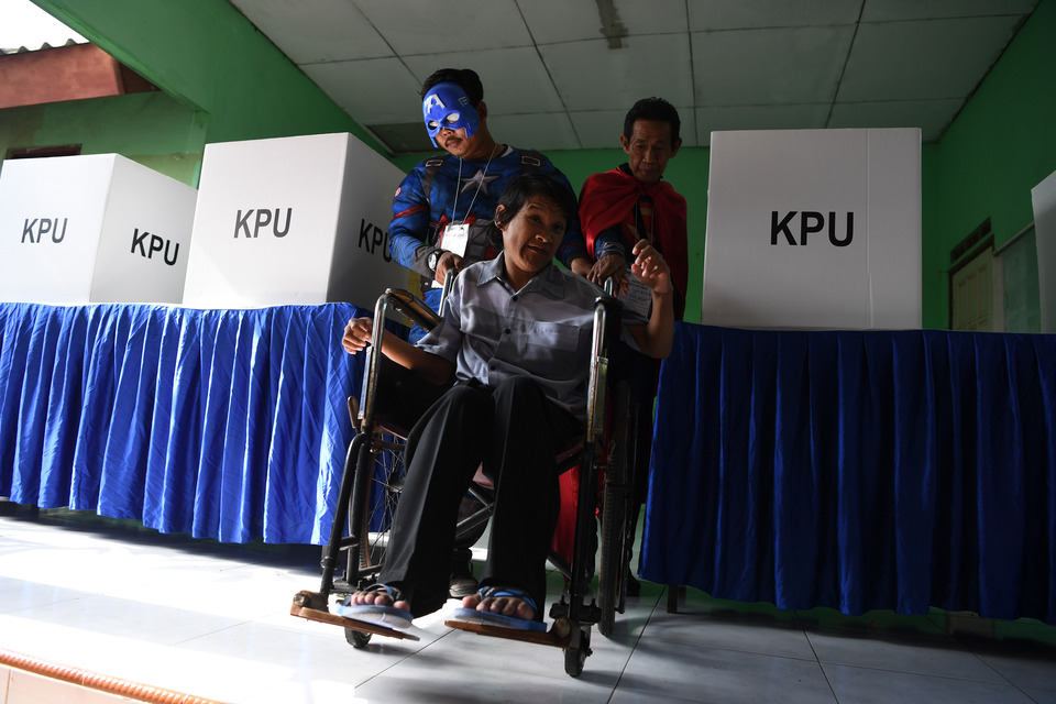 Election officials don superhero costumes at a polling booth in Surabaya, East Java, on April 17. (Antara Foto/ Zabur Karuru)