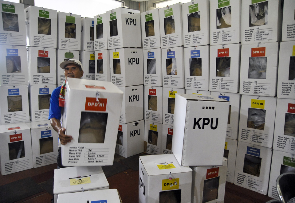 An election official stacks ballot boxes in a KPU warehouse in Bogor, West Java, last month. (Antara Photo/Arif Firmansyah)