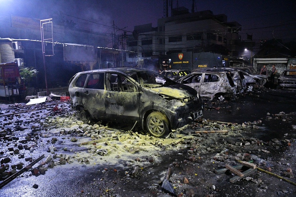 Cars were burned by rioters at a police dormitory in West Jakarta on Wednesday morning. (Antara Photo/Sigid Kurniawan)

