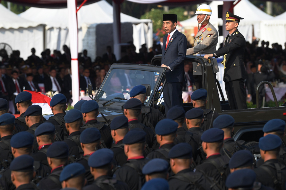 President Joko 'Jokowo' Widodo inspects the guard during the start of the National Police's 73rd anniversary celebrations at the National Monument in Central Jakarta on Wednesday. (Antara Photo/Wahyu Putro A)