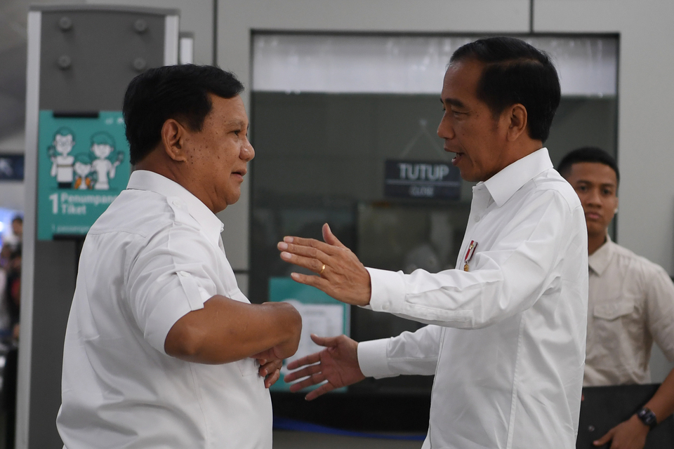 President Joko Widodo about to embrace his political rival Prabowo Subianto at the Lebak Bulus MRT Station in Jakarta on Saturday. (Antara Photo/Wahyu Putro A.)