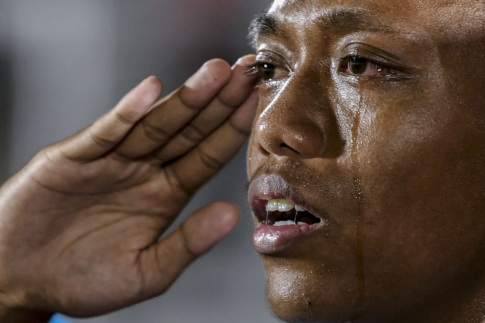 Tears stream down the face of Indonesian U-16 national football team player Aditya Rangga as he sings the national anthem. (Antara Photo/Galih Pradipta)