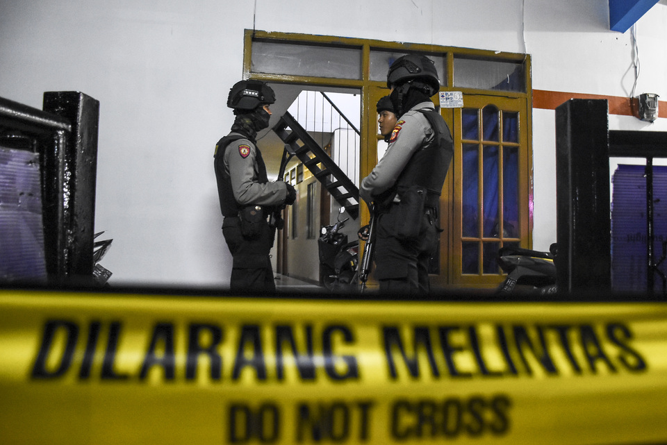 Police officers guard a house in Cimahi that was raided by police anti-terror unit Detachment 88 this week. (Antara Photo/Novrian Arbi)